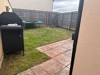 Rear garden after clearance and patio repair, with new lawn and fencing