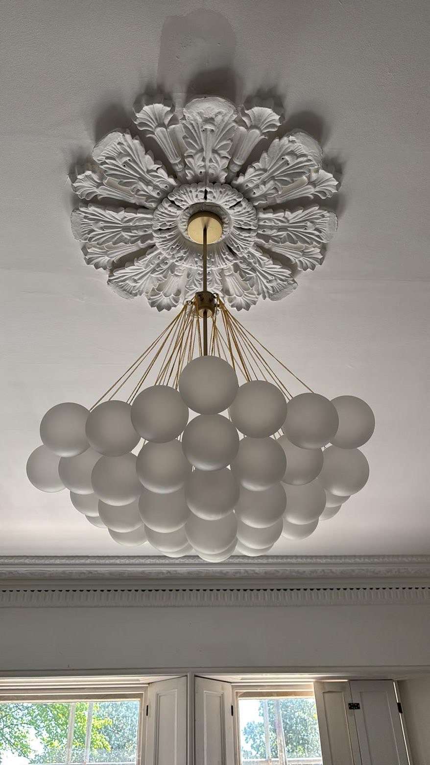 Restored plaster ceiling rose with a new multi-globe pendant light fitting installed