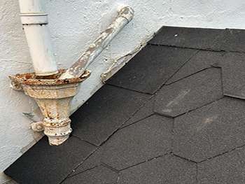 Felt flat roof edge detail with cast iron rainwater goods and hopper head